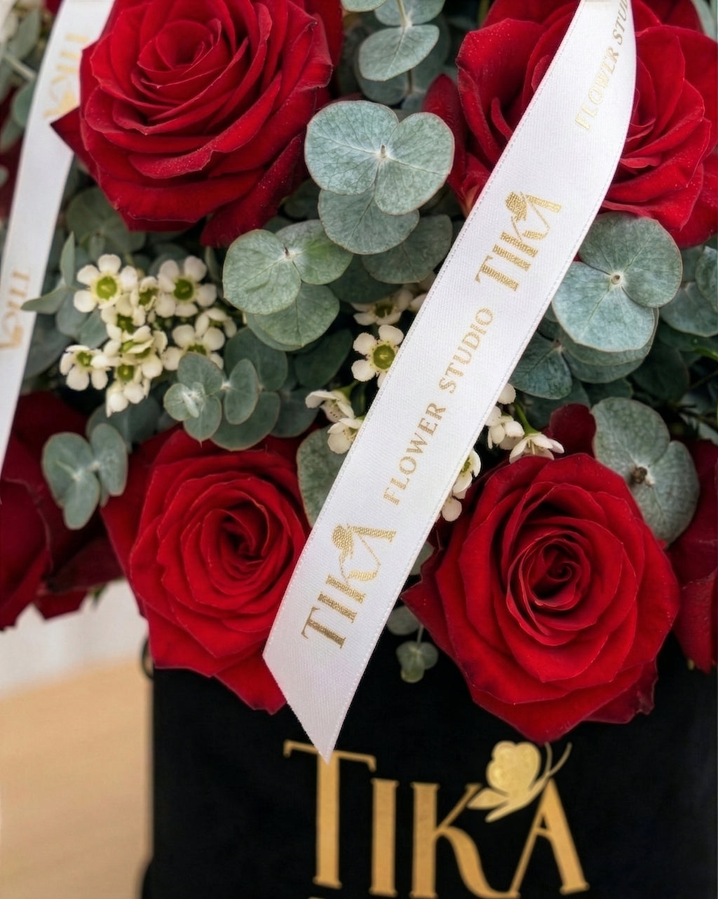“Charm” roses and eucalyptus box bouquet