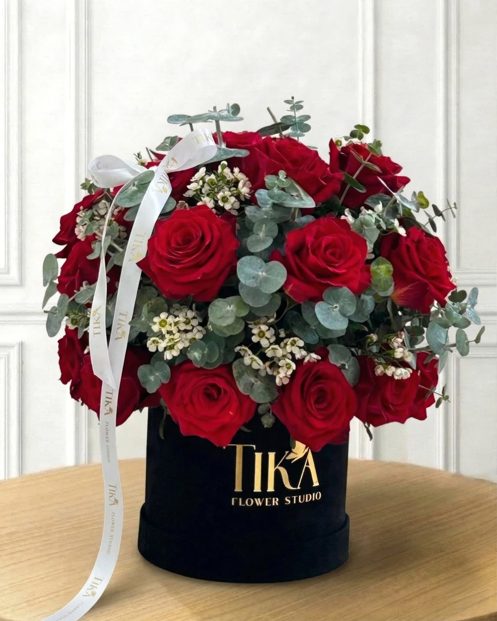 “Charm” roses and eucalyptus box bouquet