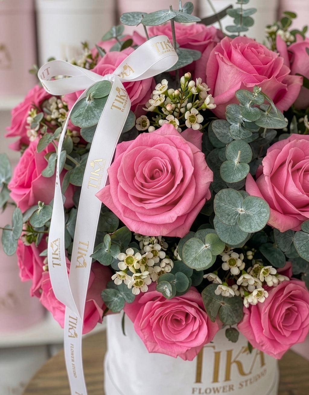“Charm Pink” roses and eucalyptus box bouquet
