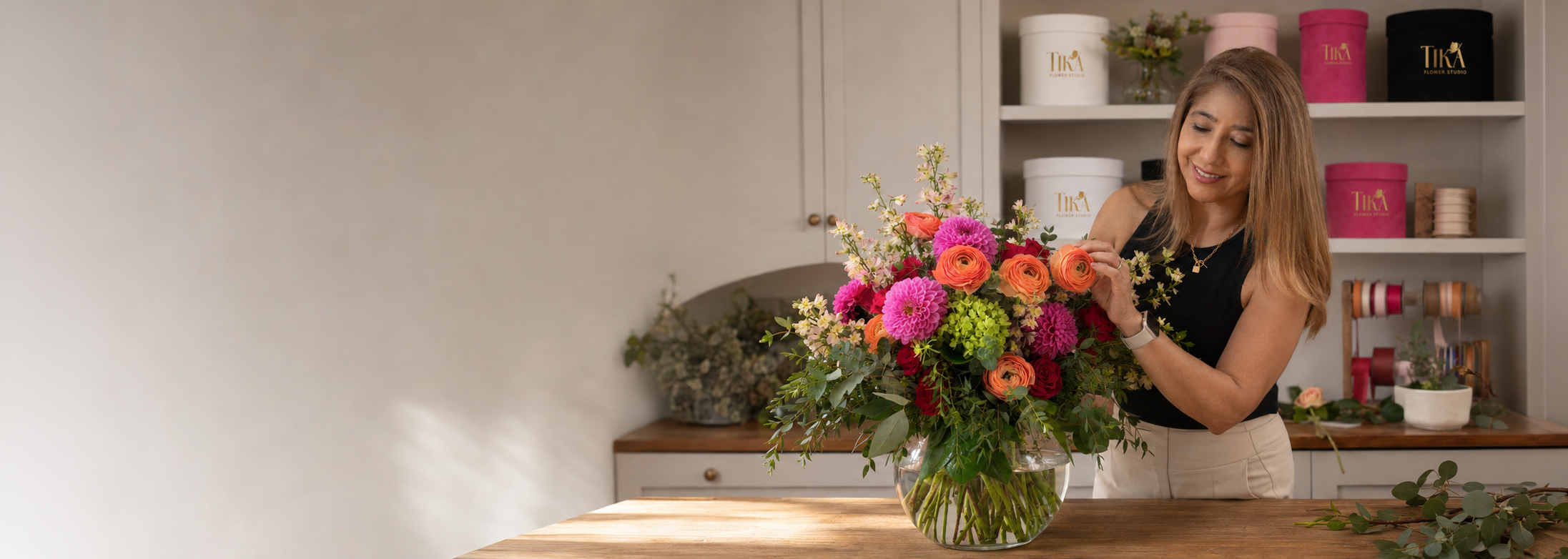 Yuli creating a colorful seasonal floral design at Tika Flower Studio in Phoenix