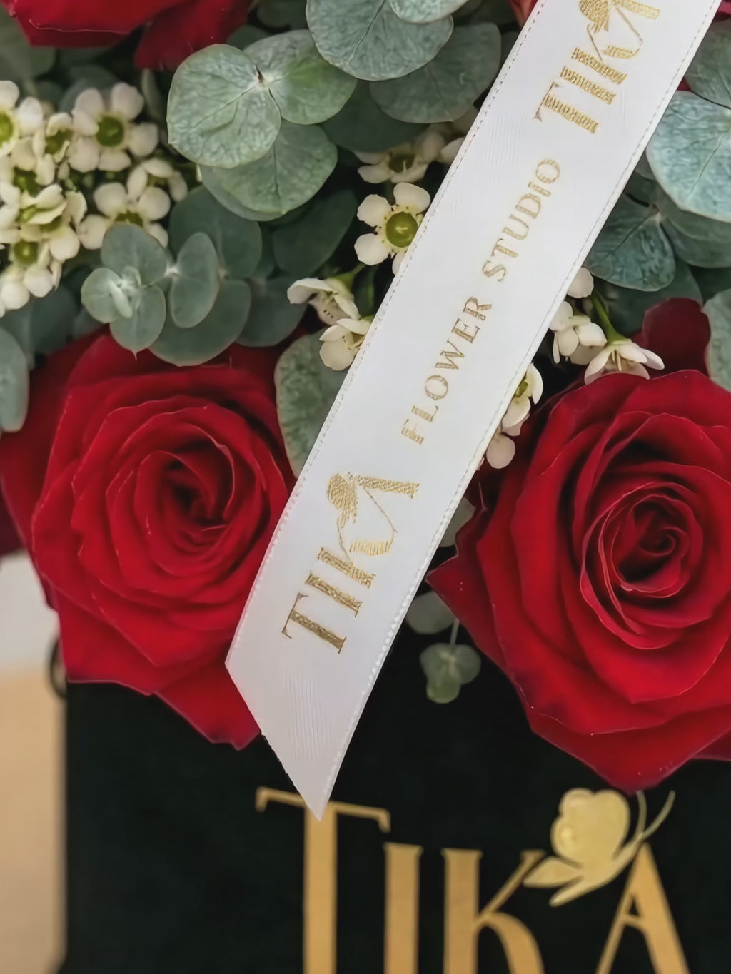 “Charm” roses and eucalyptus box bouquet